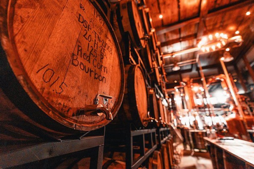 Wooden barrels with inscriptions, a dimly lit interior, and a wooden ceiling. 2