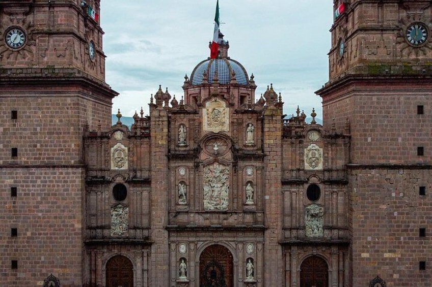 A historic building with intricate architectural details, including statues and a prominent dome. 3