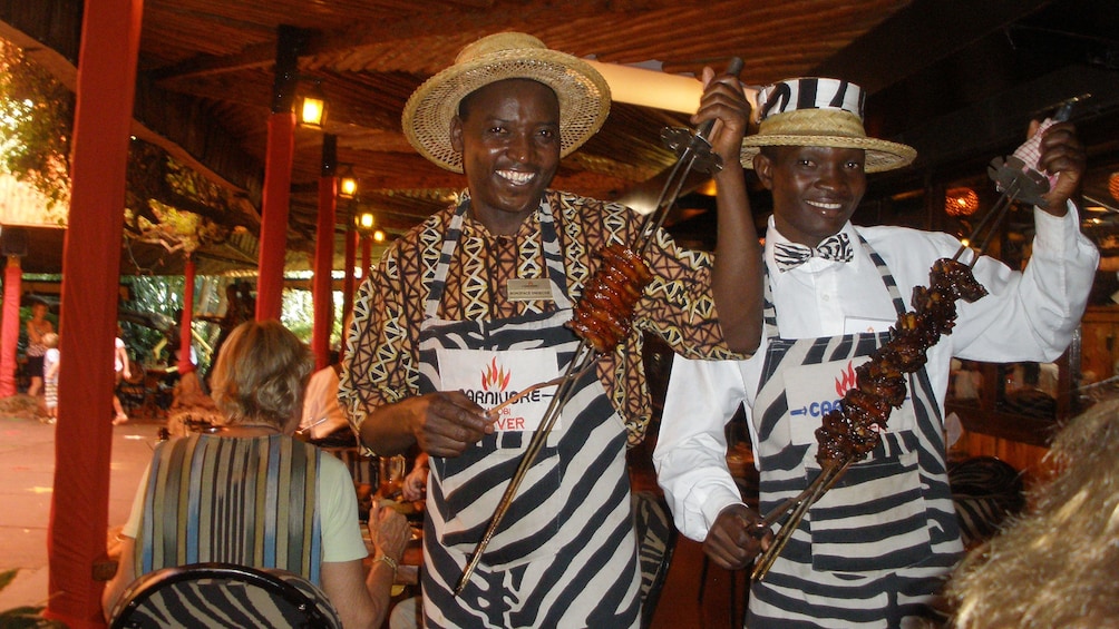 men with meat on skewers in africa