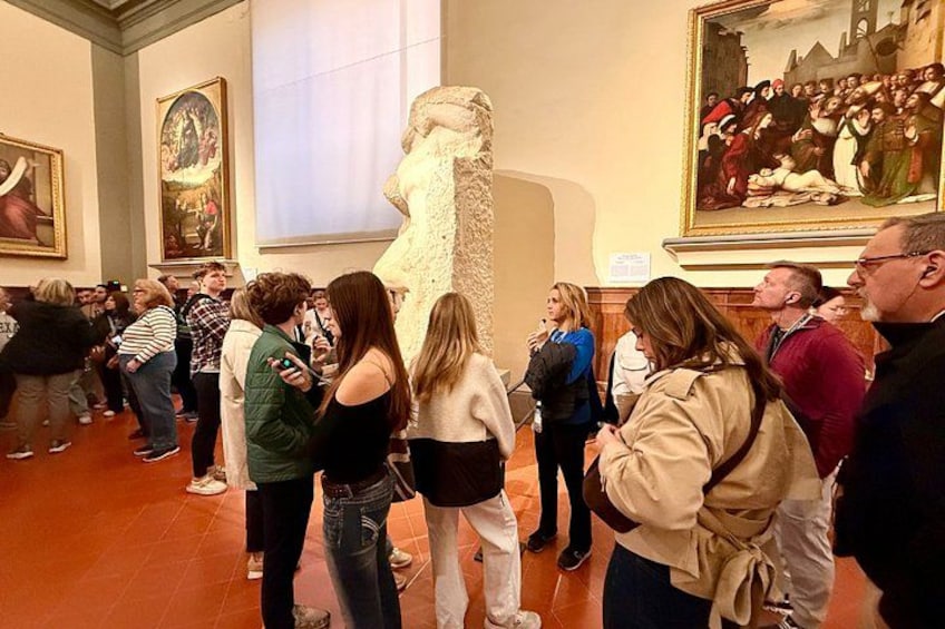 A group of people gathered around a large sculpture in a museum. 5