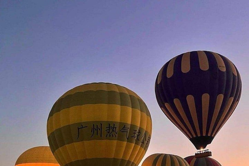 Hot air balloons with Chinese text against a twilight sky. 4