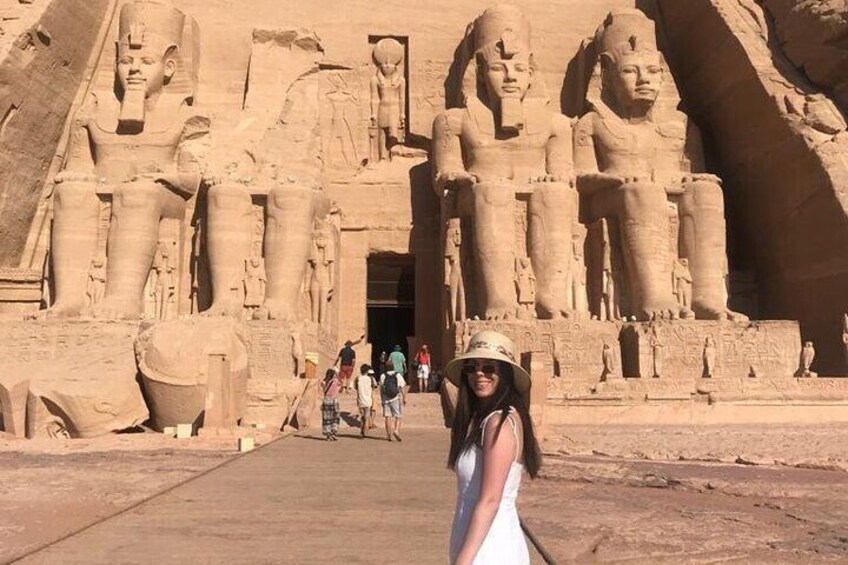 A large ancient Egyptian temple with colossal statues of pharaohs. 1