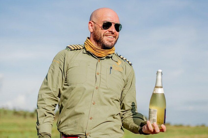 A person in a military-style jacket holding a bottle. 3