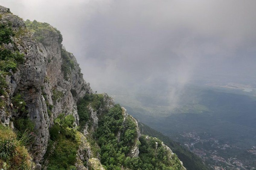 A mountainous landscape with steep cliffs and dense greenery. 5
