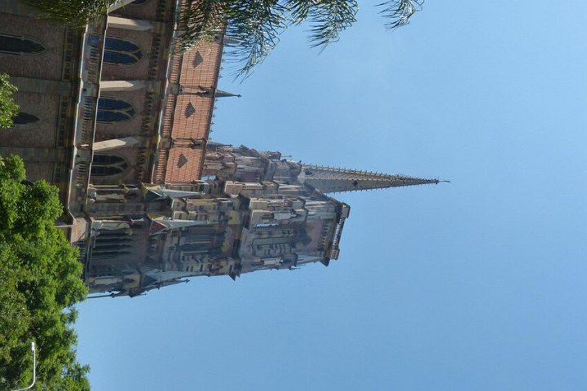 A historic church with a tall spire and arched windows. 3