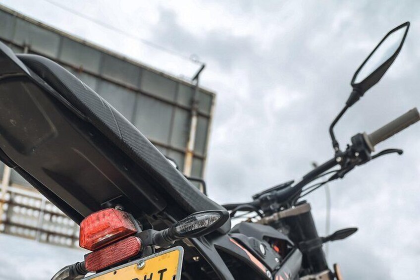 A motorcycle with a visible license plate and a red tail light. 5