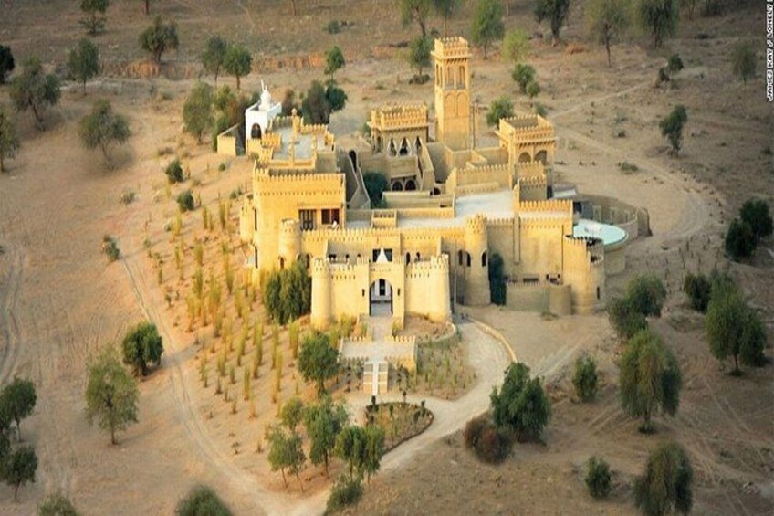 A large, fortified building with multiple towers and a central courtyard surrounded by trees. 5