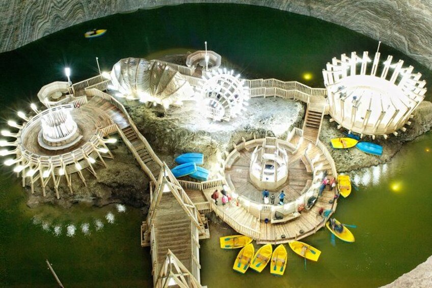 A large, illuminated water park with multiple circular platforms and walkways. 1