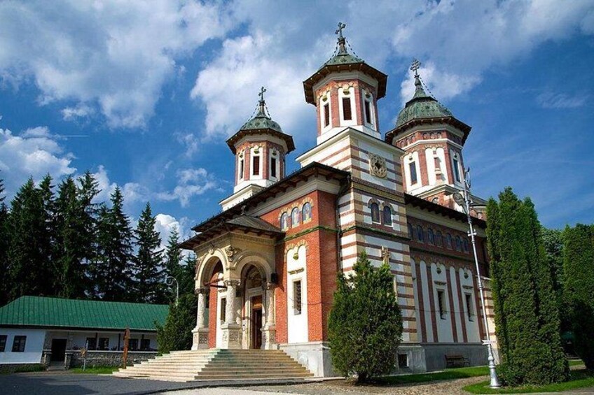 A large church with two towers and a green roof. 2