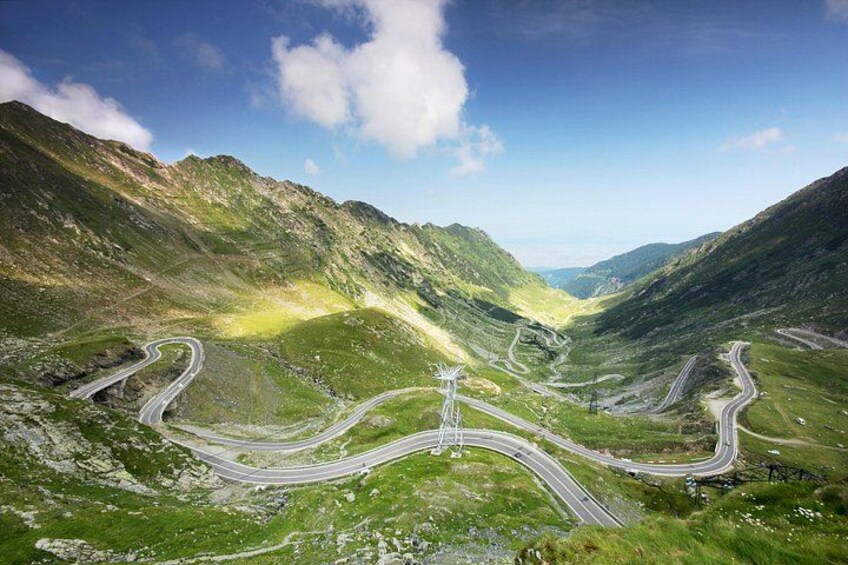 A winding mountain road with multiple forks and a clear sky. 2