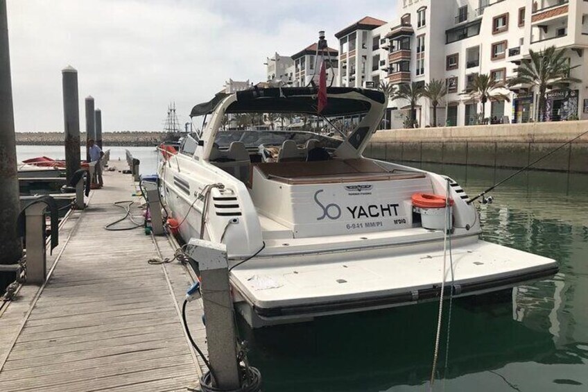 Eine weiße Yacht liegt im Hafen an einem Steg. 5