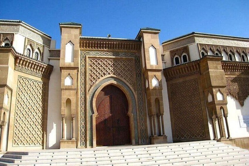 A historic building with intricate arches and detailed tile work. 1