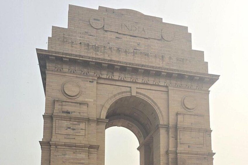 The India Gate, a large stone archway with inscriptions and decorative elements. 5