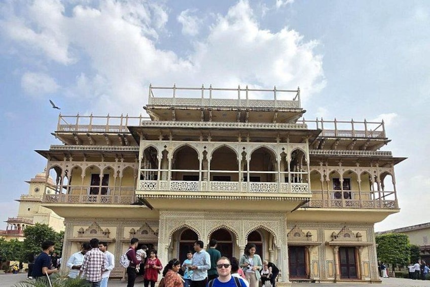 A historic building with ornate architecture, including arches and detailed carvings. 3
