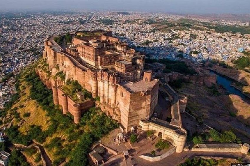 An ancient fort surrounded by a cityscape. 1