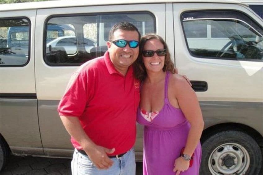 A man and a woman standing in front of a van. 2