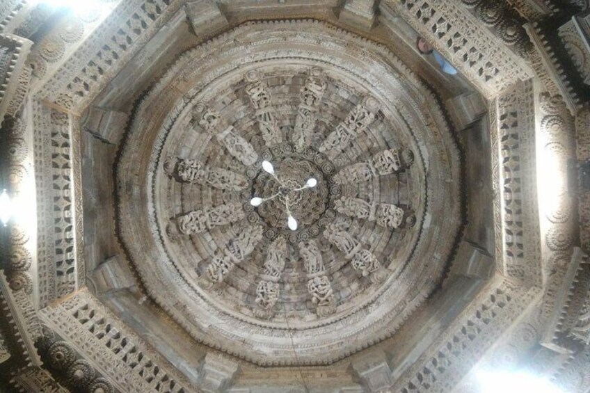 A detailed stone structure with intricate carvings and a central circular design. 2