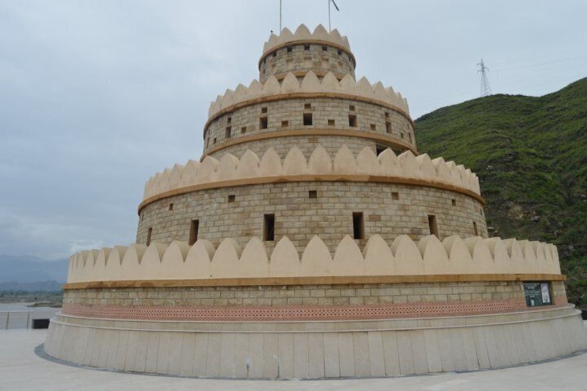 A large, multi-tiered stone structure with a flat top, surrounded by a low wall. 4