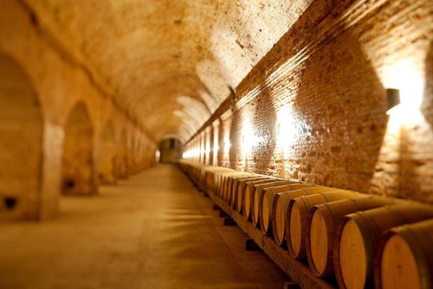 A long, dimly lit tunnel with wooden logs lining the walls. 1