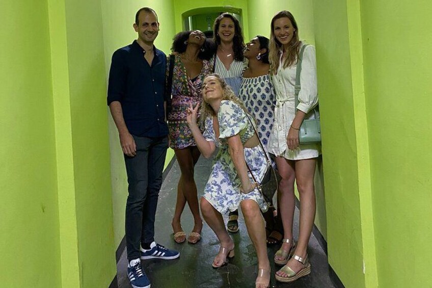 Un groupe de personnes se tient dans un couloir aux murs verts. 2