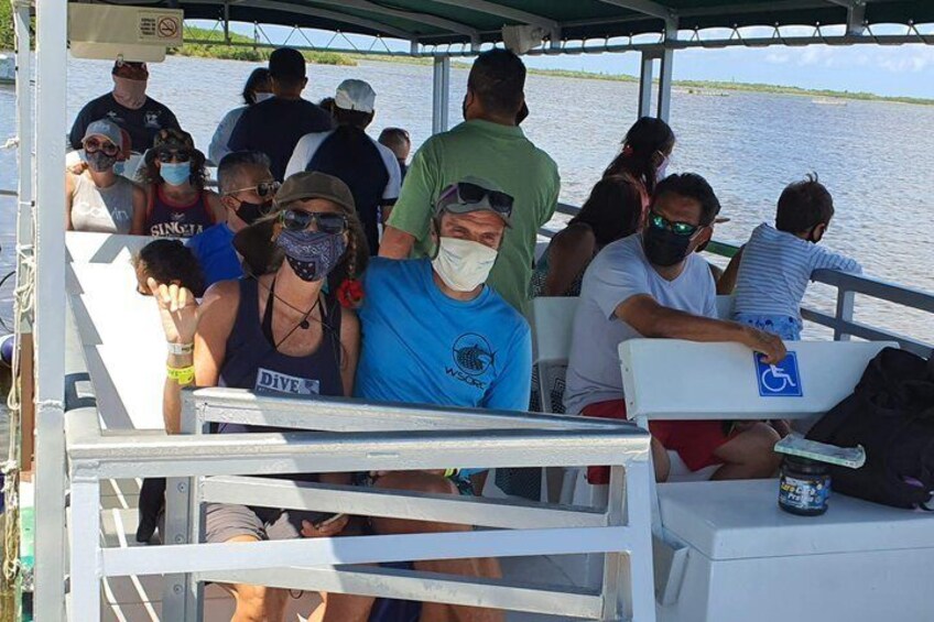 People on a boat with a water body in the background. 3