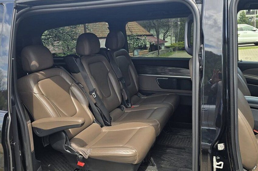 A vehicle interior with brown leather seats and a sunroof. 5