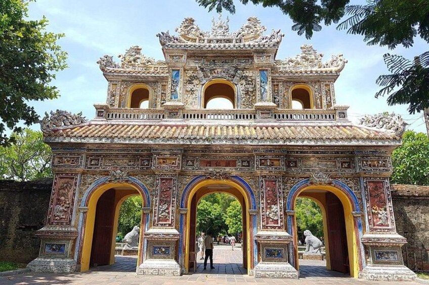 A traditional Vietnamese gate with intricate designs and multiple arches. 1