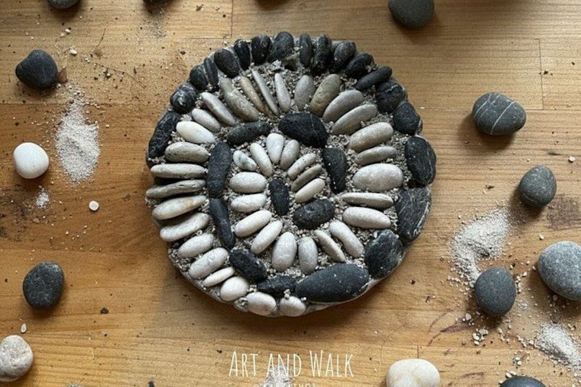A circular arrangement of stones on a wooden surface. 2