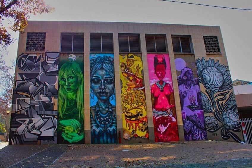 A building with colorful vertical murals. 1