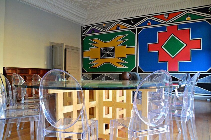The famous expensive glass table in a room personally painted by famous Ndebele artist, Esther Mahlangu 5