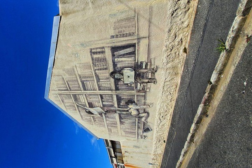 A street with a sidewalk and a building with a sign. 2