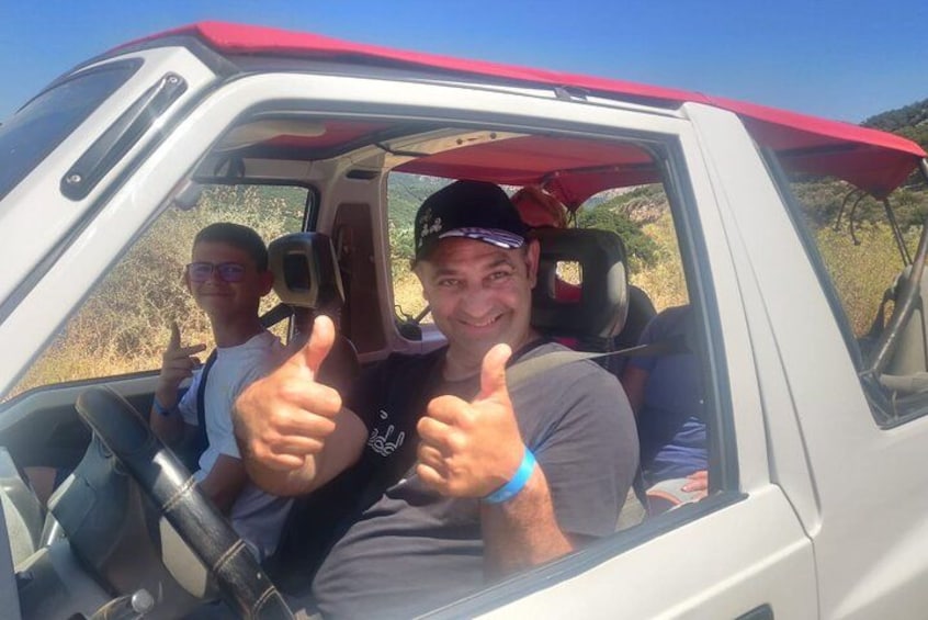 A vehicle with a red roof and a person giving a thumbs-up. 4