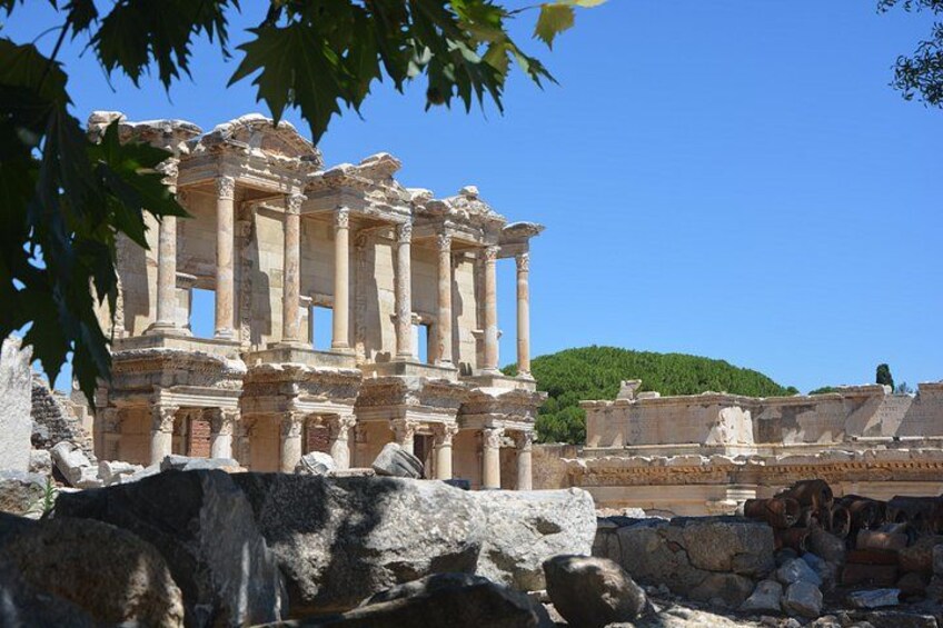 Ancient ruins with columns and a hillside in the background. 2