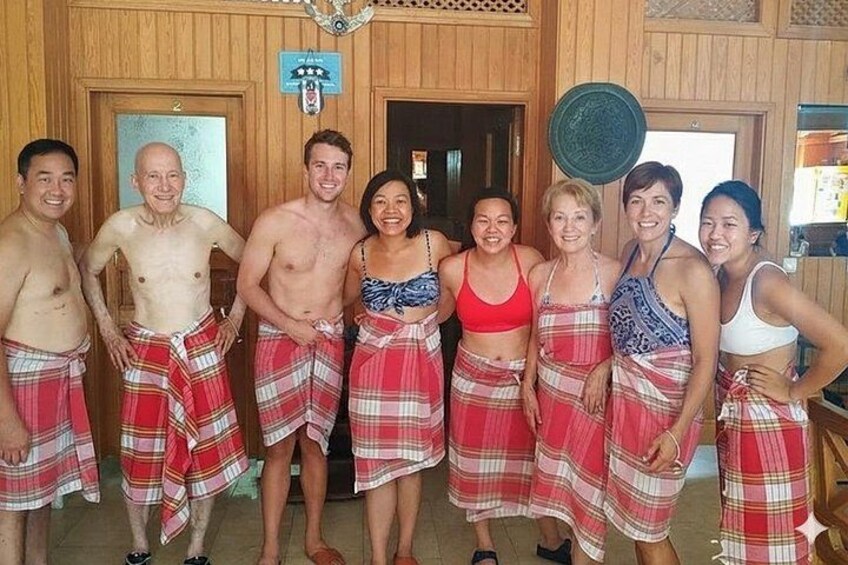A group of people in a wooden room with plaid skirts and shorts. 2