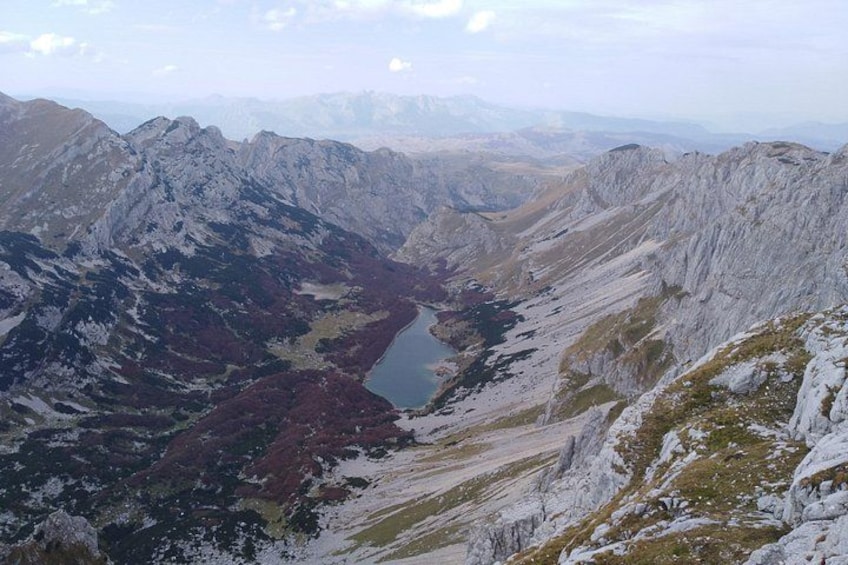 A mountainous landscape with a valley and a lake. 2