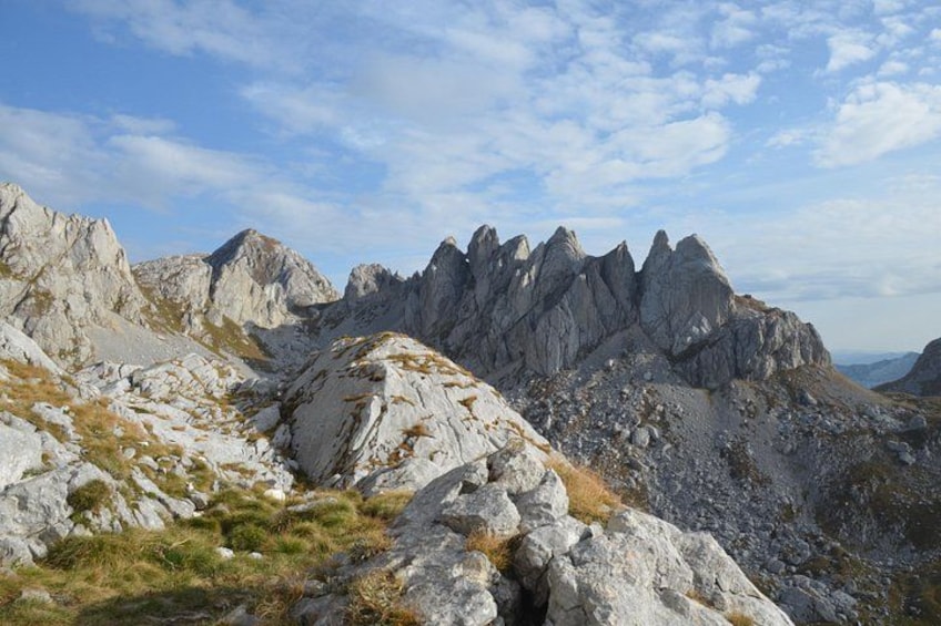 A mountainous landscape with rocky terrain and sparse vegetation. 5