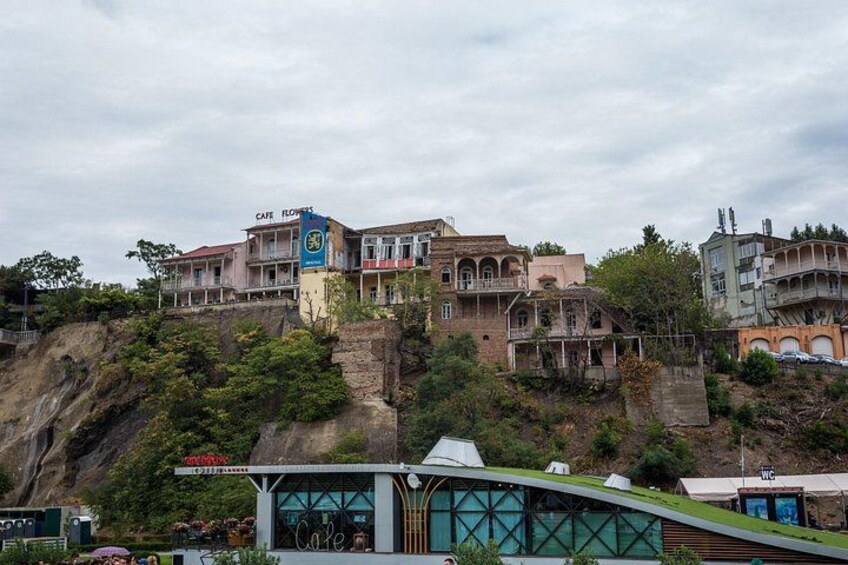 A hillside with buildings, including a cafe, and a modern structure with a green roof. 2