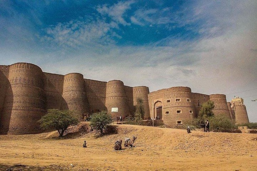 A large, ancient walled structure with multiple towers and a smaller building in the center. 1