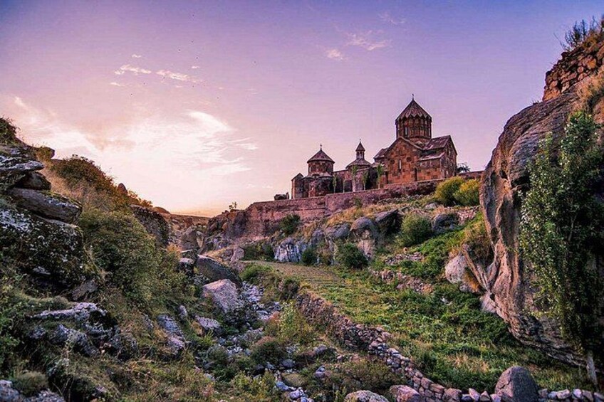 A mountainous landscape with a church and rocky terrain. 1