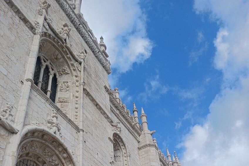 A historic building with intricate stone carvings and a clear blue sky. 4