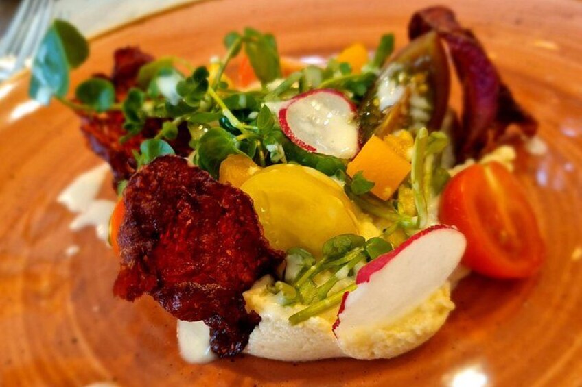 A plate of food with a variety of vegetables and a piece of meat. 5