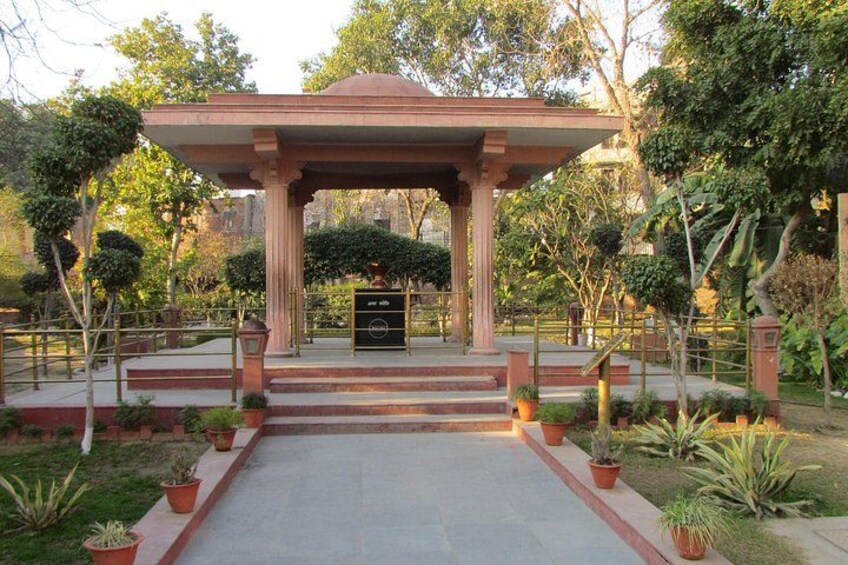 A gazebo with a red roof, surrounded by potted plants and trees. 3