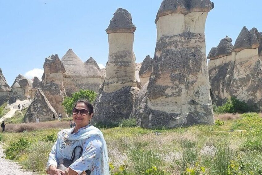 A person standing in front of unique rock formations. 3