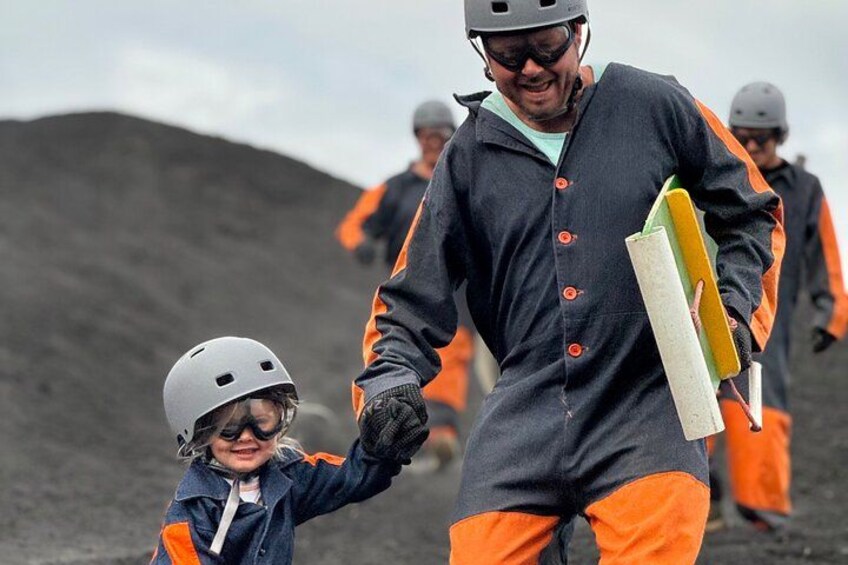 People in orange and gray uniforms, helmets, and holding a yellow object. 2