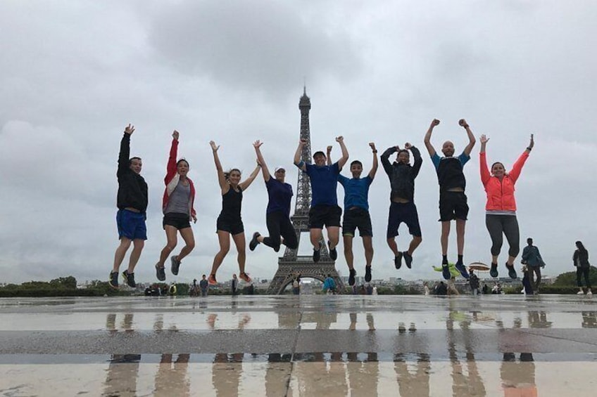 A group of people jumping in front of the Eiffel Tower. 2