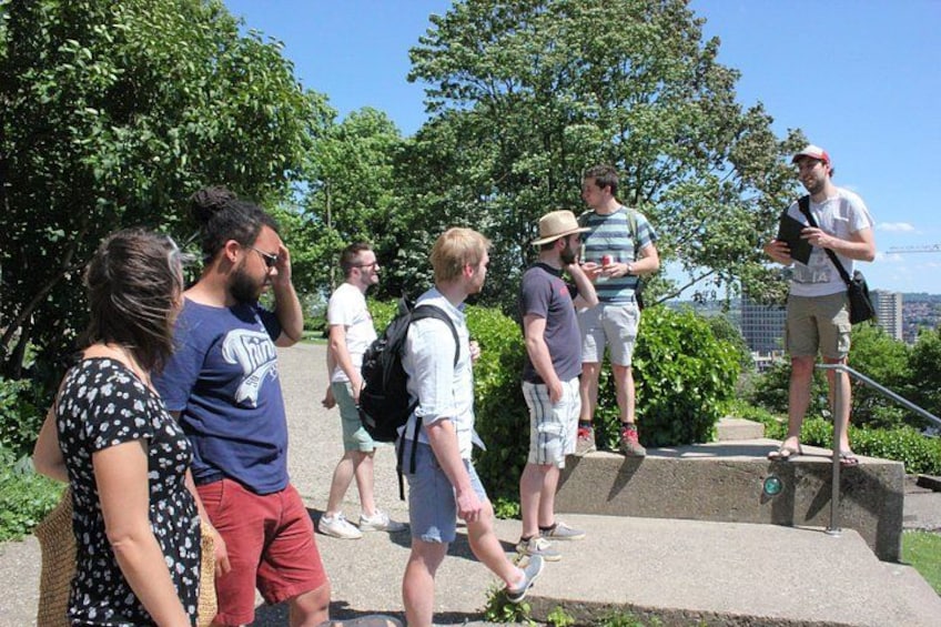 A group of people walking on a concrete path surrounded by greenery. 4