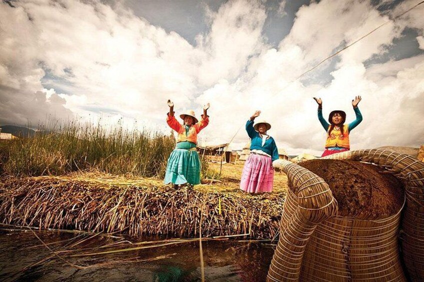 Three people standing on a field with a large woven basket in the foreground. 4