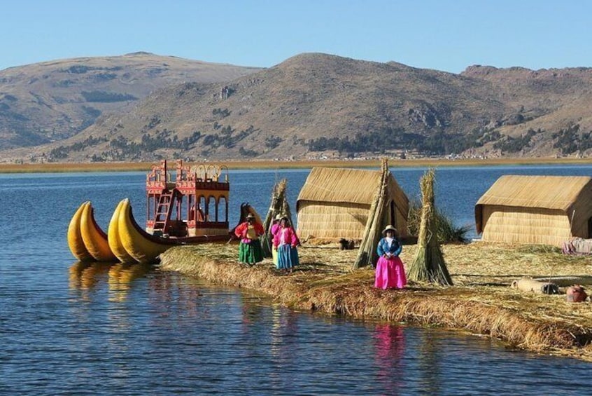 A lake with canoes, a wooden structure, and traditional huts. 1