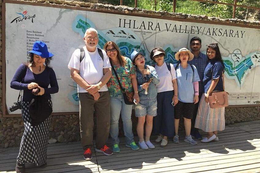A group of people standing in front of a sign for Ihlara Valley/Aksaray. 2