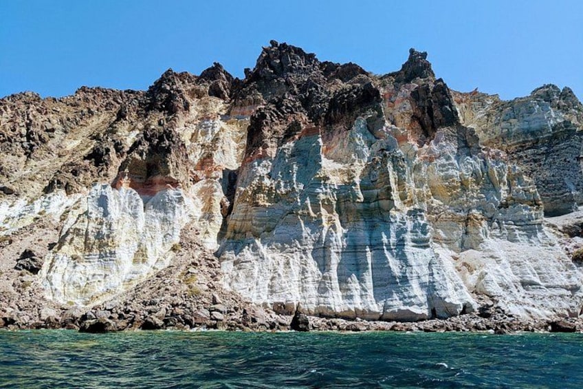 Rocky formations at White beach . Escape to a pristine white beach, with multicolored cliffs, where soft sands and breathtaking scenery create the perfect setting for a luxurious retreat. 3